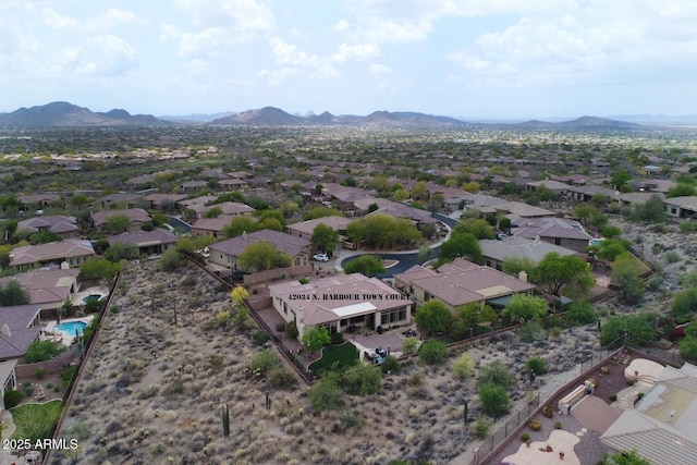 birds eye view of property with a mountain view