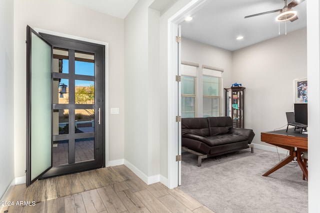 foyer entrance with light hardwood / wood-style flooring and ceiling fan