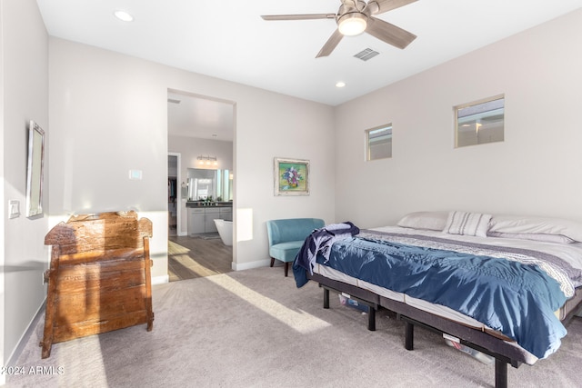 bedroom featuring ensuite bathroom, ceiling fan, and carpet floors