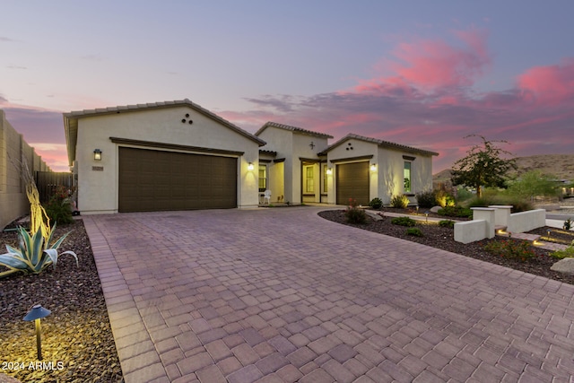 mediterranean / spanish-style house with a garage