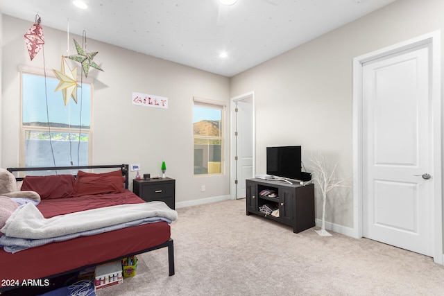 bedroom with light colored carpet and ceiling fan