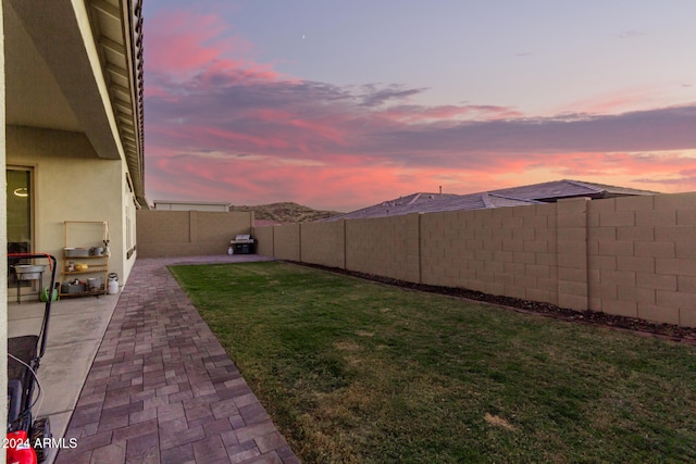 yard at dusk with a patio