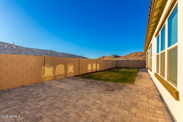 view of yard with a mountain view and a patio