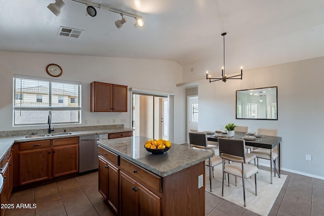 2518 W Carson Rd, Phoenix, AZ 85041 - kitchen with stainless steel dishwasher, a sink, lofted ceiling, light tile patterned floors, and a chandelier