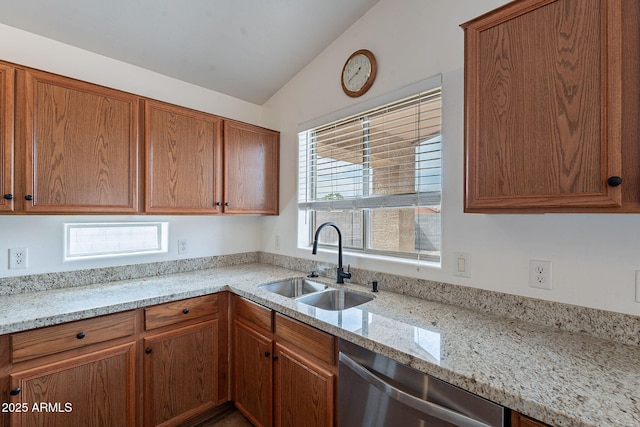2518 W Carson Rd, Phoenix, AZ 85041 - kitchen with a sink, stainless steel dishwasher, light stone countertops, vaulted ceiling, and brown cabinetry