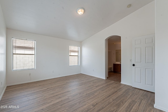 2518 W Carson Rd, Phoenix, AZ 85041 - spare room with arched walkways, wood finished floors, and baseboards