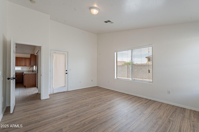 2518 W Carson Rd, Phoenix, AZ 85041 - spare room featuring wood finished floors, baseboards, and a sink