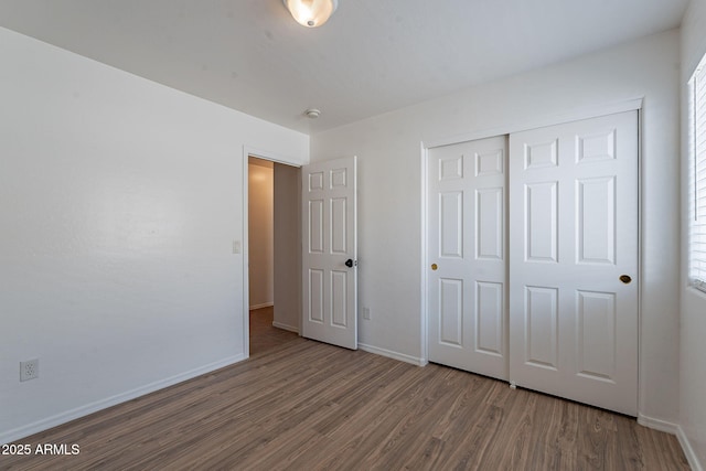 2518 W Carson Rd, Phoenix, AZ 85041 - unfurnished bedroom with wood finished floors, baseboards, and a closet