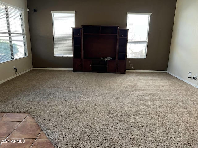 carpeted spare room with a healthy amount of sunlight