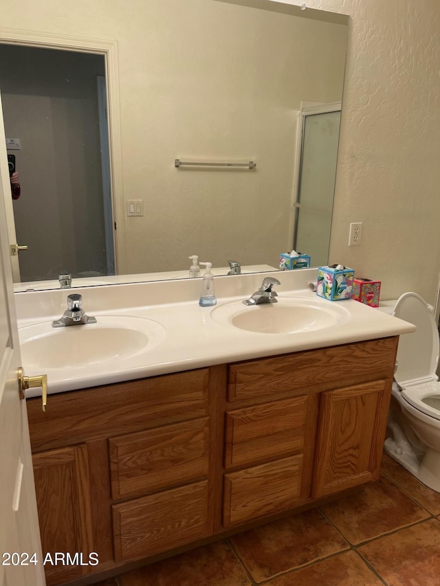 bathroom featuring tile patterned floors, vanity, and toilet