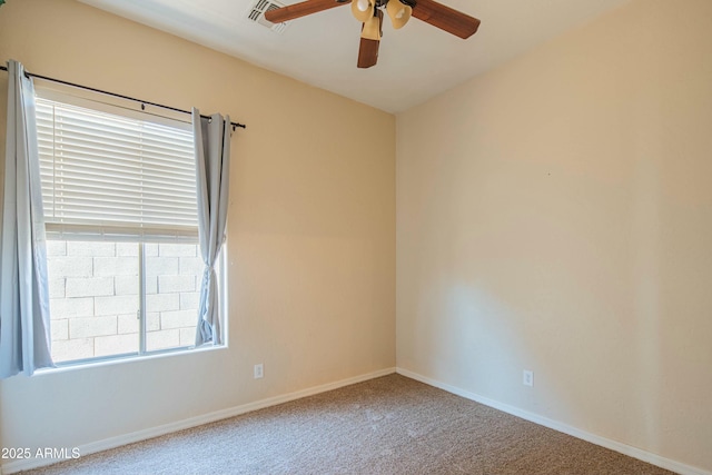 carpeted spare room featuring plenty of natural light and ceiling fan