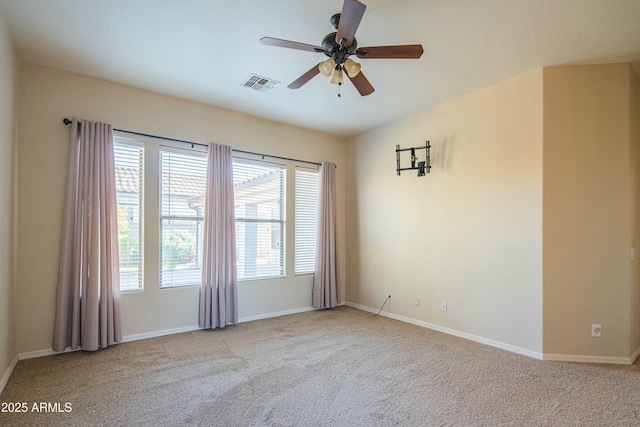 empty room featuring ceiling fan and light colored carpet