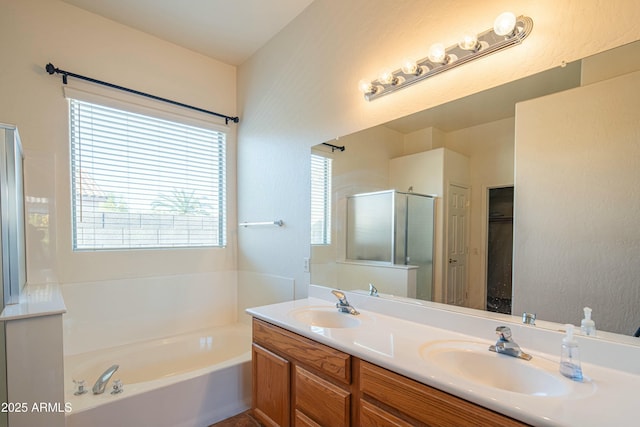 bathroom with vanity and separate shower and tub