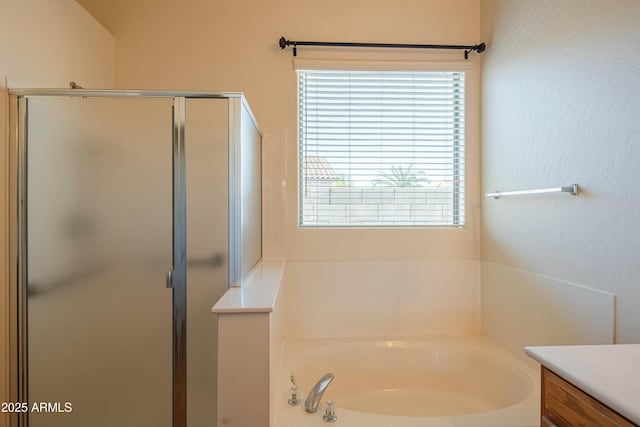 bathroom featuring vanity and plus walk in shower