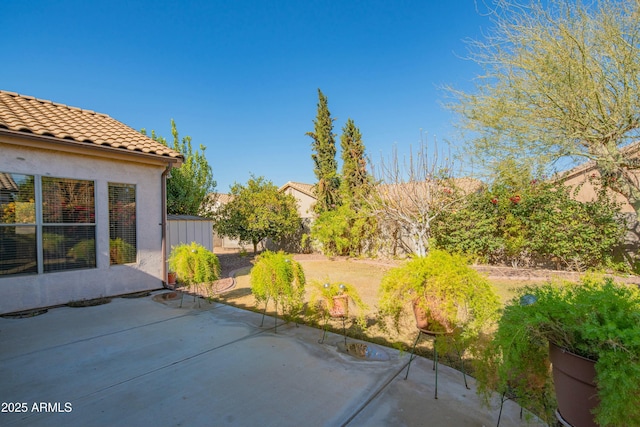 view of patio featuring a storage unit