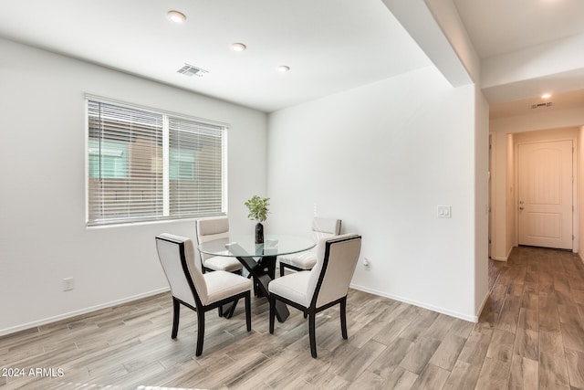 dining space with light hardwood / wood-style floors