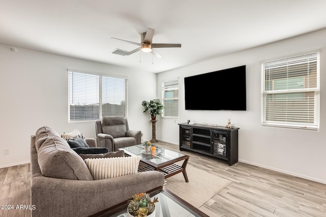 living room with light hardwood / wood-style floors and ceiling fan