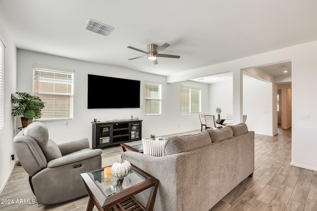 living room featuring ceiling fan and light wood-type flooring