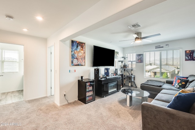 living room with light carpet, plenty of natural light, and ceiling fan