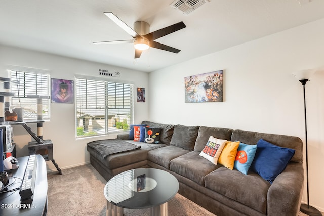 living room with ceiling fan and carpet