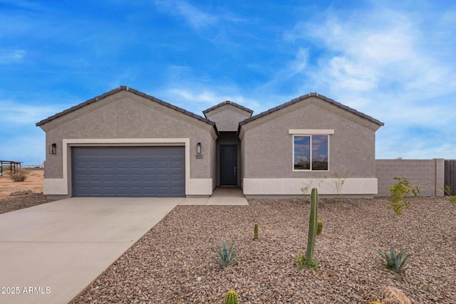 ranch-style home featuring stucco siding, a garage, driveway, and fence