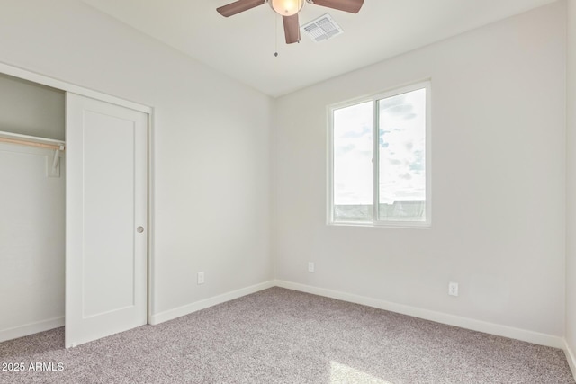 unfurnished bedroom with visible vents, a ceiling fan, a closet, carpet flooring, and baseboards