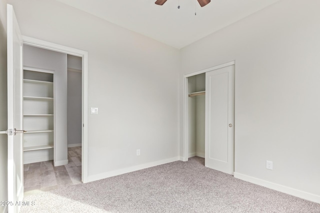 unfurnished bedroom featuring a ceiling fan, carpet, a closet, and baseboards