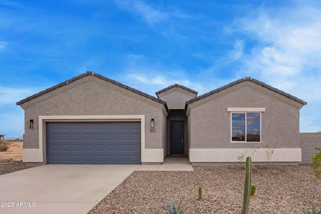 single story home with stucco siding, a tiled roof, concrete driveway, and a garage