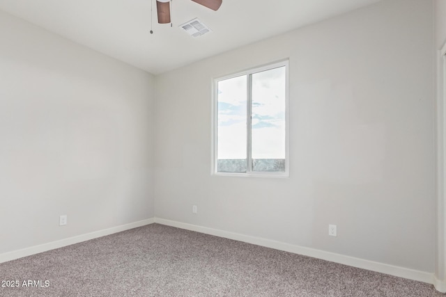 carpeted empty room featuring visible vents, baseboards, and ceiling fan