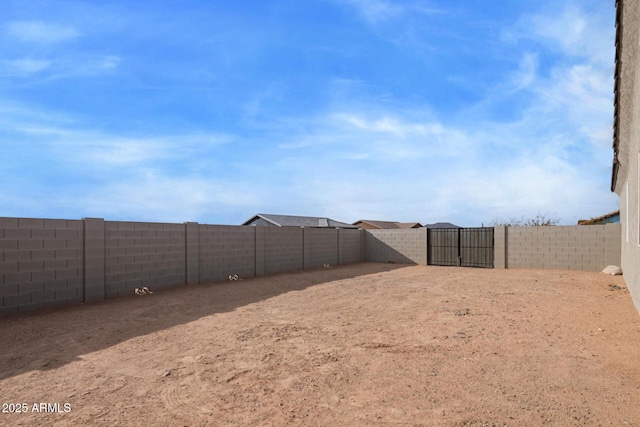 view of yard featuring a gate and a fenced backyard