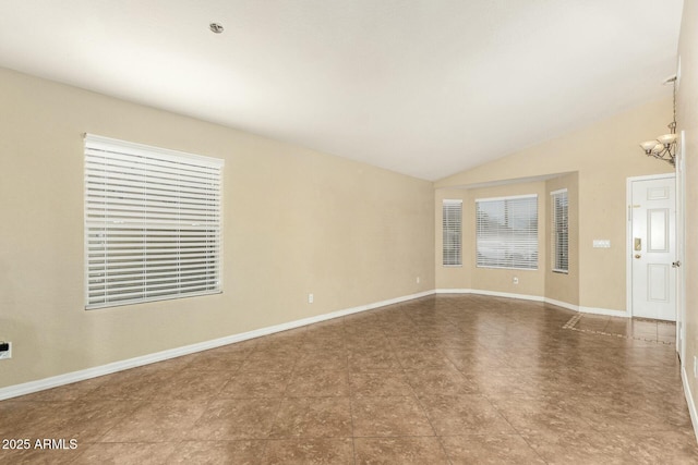 unfurnished living room featuring lofted ceiling and a chandelier