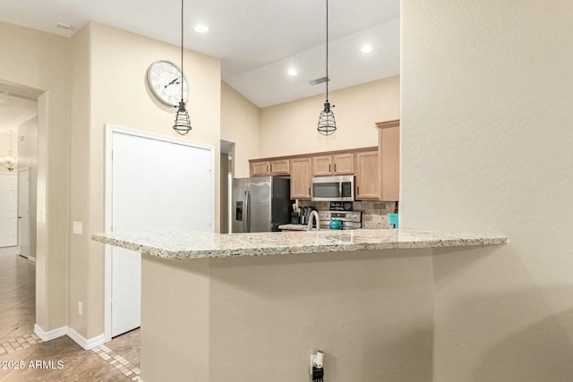 kitchen featuring decorative light fixtures, kitchen peninsula, decorative backsplash, and appliances with stainless steel finishes