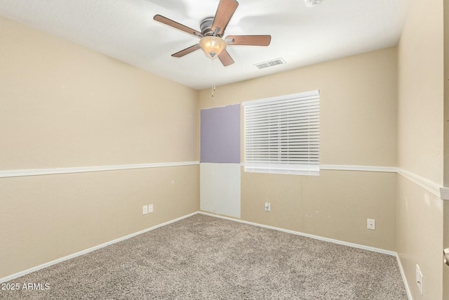 spare room featuring ceiling fan and carpet floors