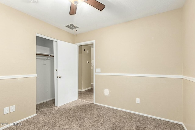 unfurnished bedroom with carpet floors, ceiling fan, and a closet