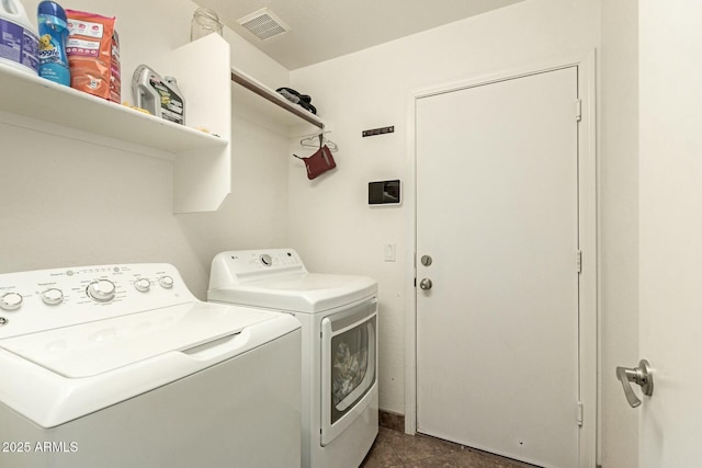 clothes washing area with washing machine and clothes dryer