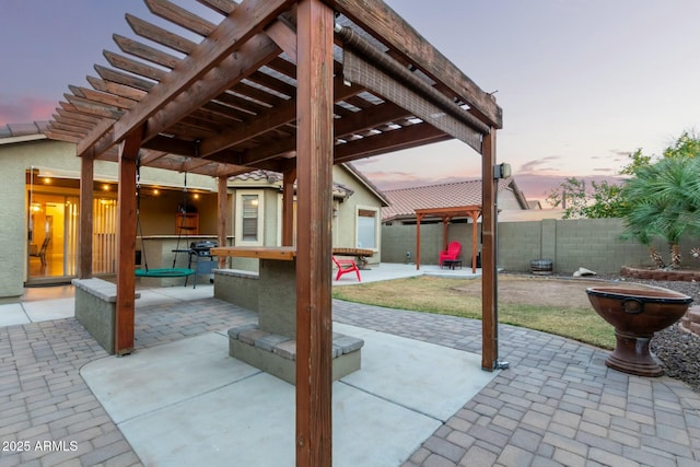 patio terrace at dusk with a pergola