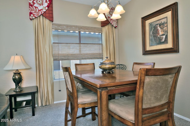 carpeted dining area featuring a healthy amount of sunlight and a notable chandelier