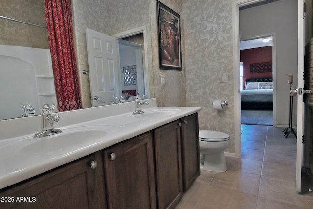 bathroom featuring vanity, toilet, and tile patterned flooring