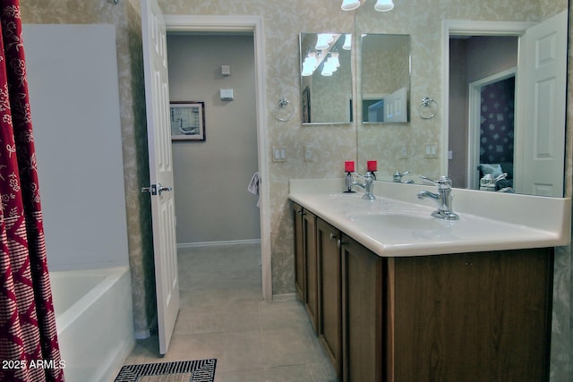 bathroom featuring vanity, tile patterned flooring, and a bathtub