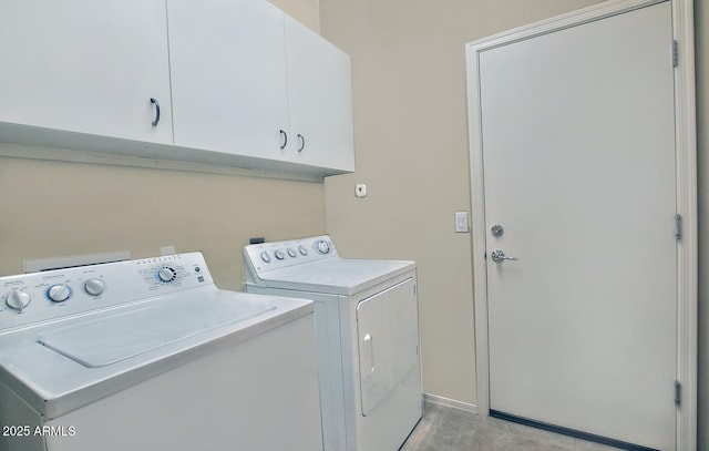 laundry area featuring independent washer and dryer and cabinets