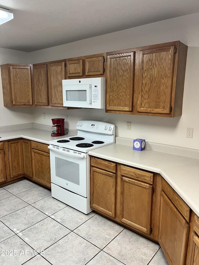 100 N Lariat Way, Payson, AZ 85541 - kitchen featuring white appliances, brown cabinetry, light tile patterned floors, and light countertops