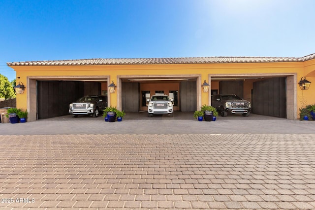 garage featuring decorative driveway