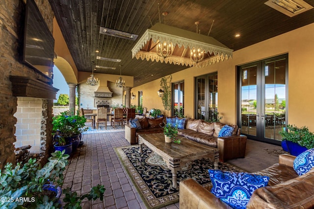 view of patio / terrace featuring french doors and an outdoor living space with a fireplace