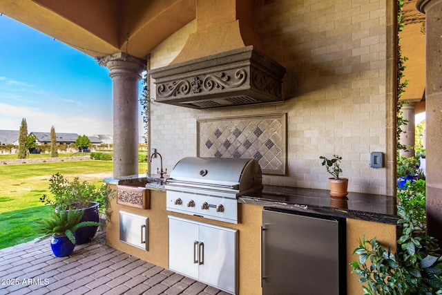 view of patio with area for grilling and a sink