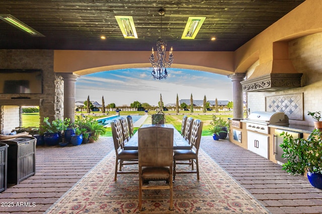 view of patio / terrace featuring a fireplace, an outdoor kitchen, area for grilling, outdoor dining space, and an outdoor pool