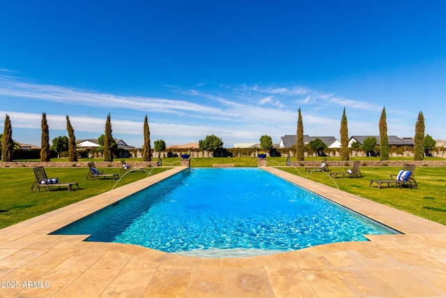 outdoor pool with a residential view, a patio area, and a lawn