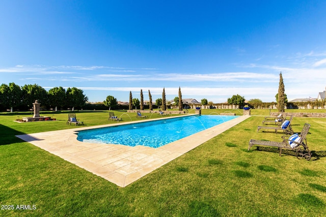 pool featuring a patio area and a yard