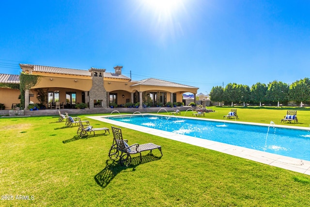 pool featuring a lawn and a patio