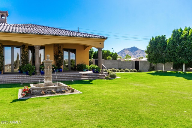 view of yard with a mountain view and fence