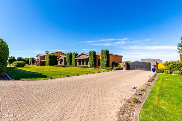 view of front of house with a tile roof, a residential view, a front lawn, and decorative driveway